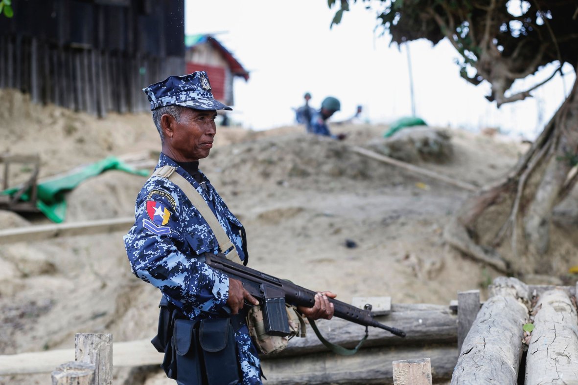 A Myanmar border guard policeman patrols a police station in Buthidaung on 7 January following attacks launched three days earlier by Arakan Army insurgents. (AFP/Getty Images)