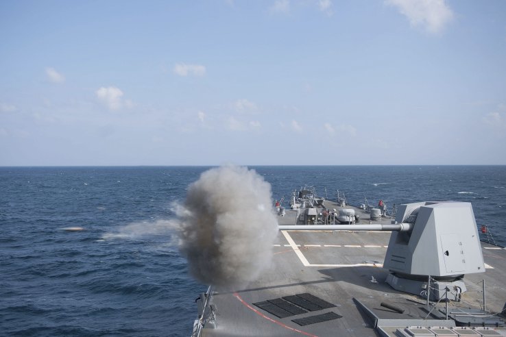 
        The USN Arleigh-Burke class guided-missile destroyer USS
        Jason Dunham
        (DDG 109) fires its MK 45 5-inch gun during a gunnery exercise in the Gulf of Aden in 2018.
       (US Navy)