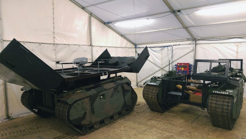 The two configurations of the THeMIS that participated in Exercise ‘Autonomous Warrior’: the one on the left is equipped with the KX-4 LE Titan unmanned aerial vehicle (UAV) while the one on right is the logistics version that can carry a payload of 750 kg. (IHS Markit/Melanie Rovery)