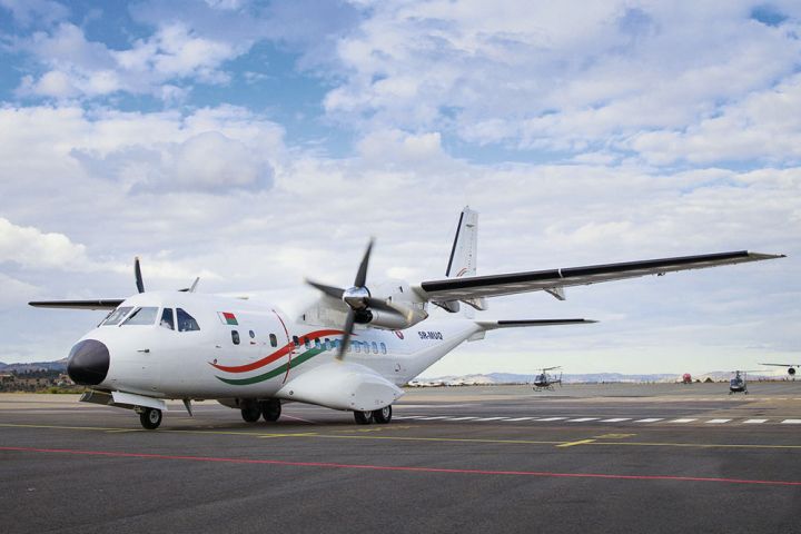 Madagascar’s new CN235 transport aircraft and two of the three AS350B2 helicopters are seen during the official handover ceremony at Ivato International Airport on 24 June. (Presidence de Madagascar)