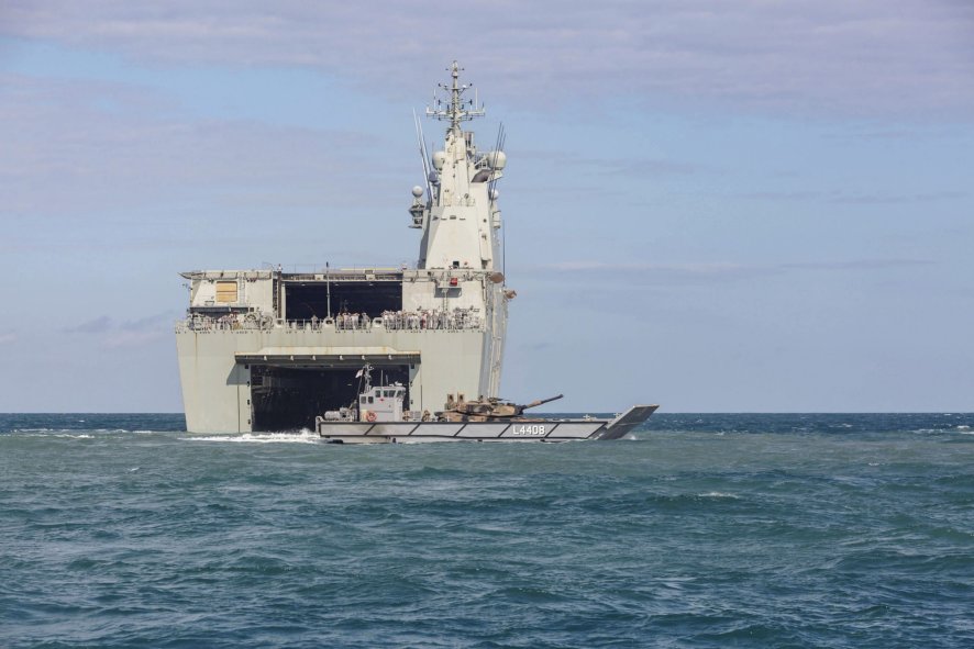 
        An LCM-1E landing craft embarked with an Australian Army M1A1 main battle tank, leaving the well dock of HMAS
        Canberra
        .
       (Chief of Navy Australia)