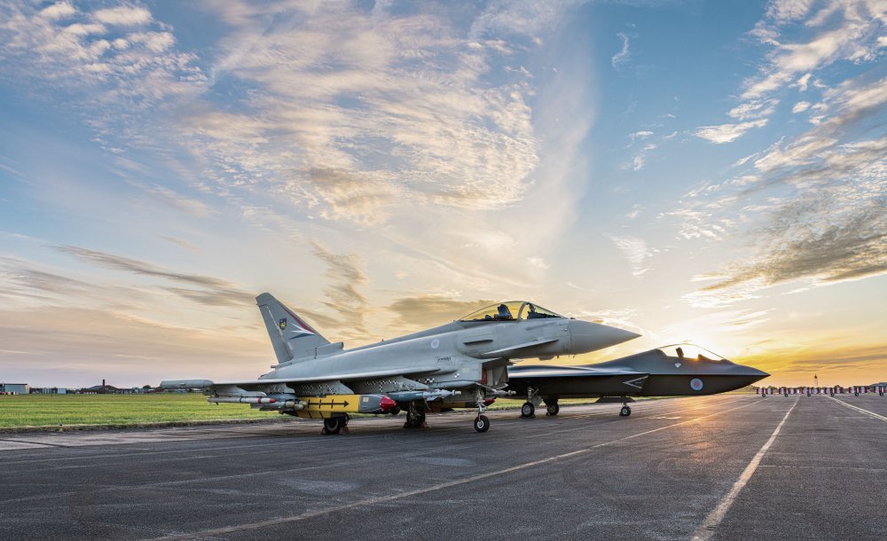 A Eurofighter Typhoon sits alongside a concept model of Tempest, a vision of the UK’s future combat aircraft, at BAE Systems' site in Warton, Lancashire. (BAE Systems)