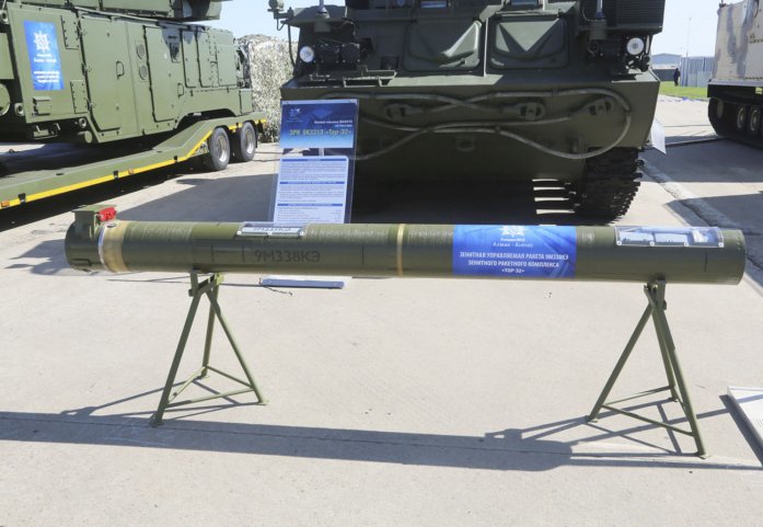 A 9M338KE surface-to-air guided missile displayed in its container in front of a Tor-E2 tracked combat vehicle at the MAKS 2019 International Air Show. (N Novichkov)