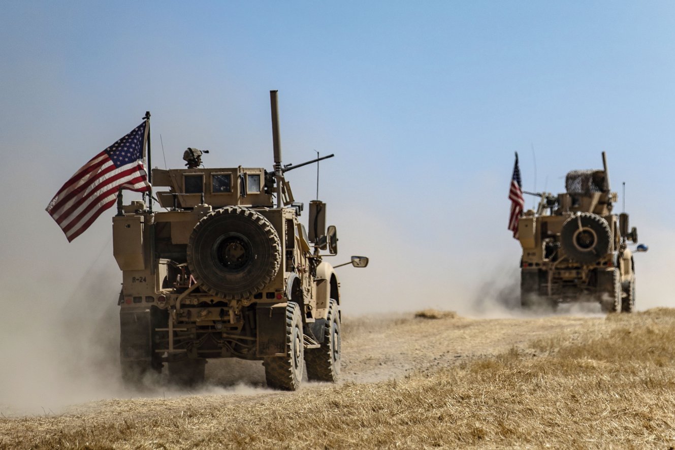 A US military convoy participates in joint patrol with Turkish troops in the Syrian village of al-Hashisha on the outskirts of Tell Abyad along the border with Turkish troops on 8 September. The US has approximately 1,000 troops inside Syria on safe zone operations and operations to defeat the Islamic State. (Delil Souleiman/AFP/Getty Images)