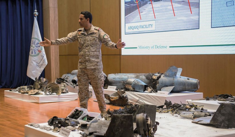 Saudi military spokesman Colonel Turki al-Maliki stands amongst the remnants of cruise missiles and UAVs recovered after the 14 September attacks on Saudi oil facilities. (Saudi Ministry of Defence)