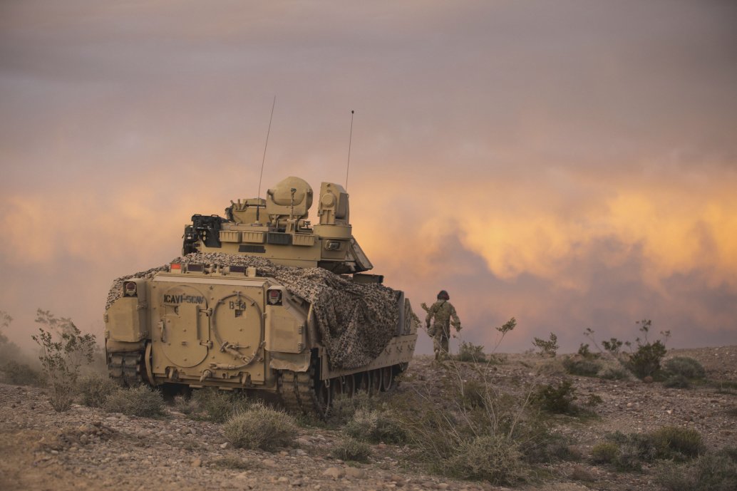 An M2 Bradley fighting vehicle covers dismounted units from 2nd Armored Brigade Combat Team during field exercises at Fort Irwin, California. (Credit: US Army )